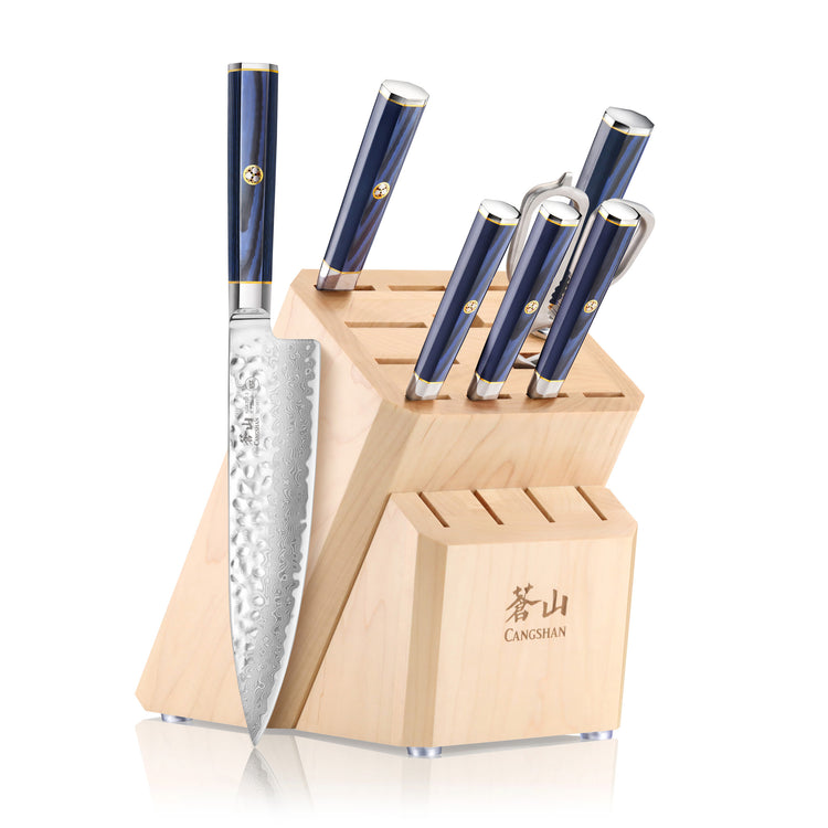 Wooden knife block with six knives featuring blue handles and hammered steel blades, some slots empty.