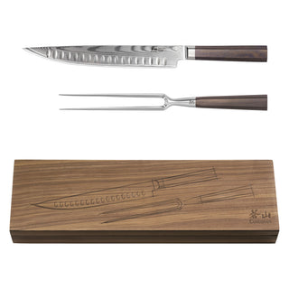 
                    
                      Two-piece carving set with a Damascus steel knife and fork, both with wooden handles, displayed above a wooden storage box.
                    
                  