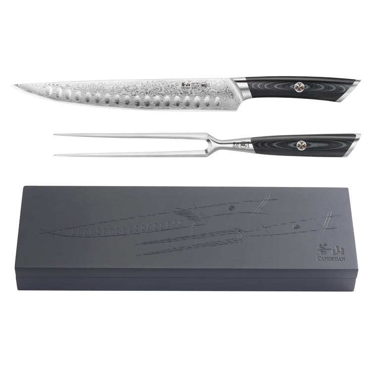Carving knife and fork with black handles and patterned blades, displayed above a black storage box with embossed knife desig