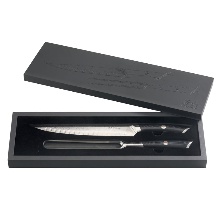 Two knives with black handles and a sharpening steel in a black rectangular box with a matching lid.