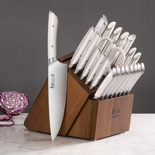 
                    
                      23-piece knife set with stainless steel knives in an acacia wood block on a marble surface.
                    
                  
