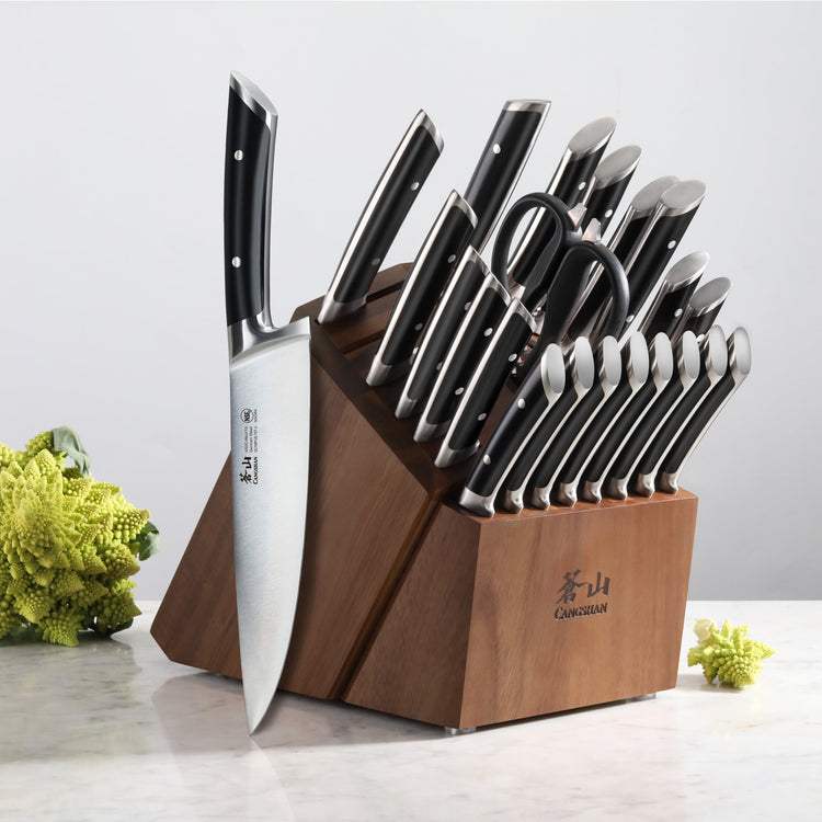 23-piece knife set with black handles in a wooden block, including chef knife, paring knives, and kitchen scissors.