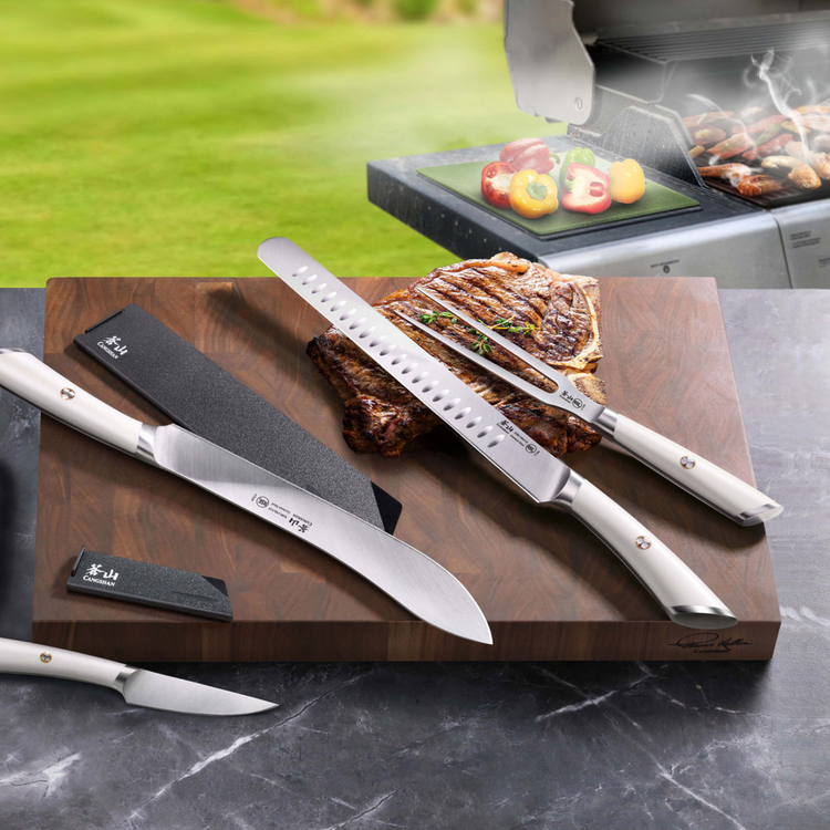 Six-piece BBQ knife set with white handles displayed on a wooden board with grilled meat and vegetables nearby.