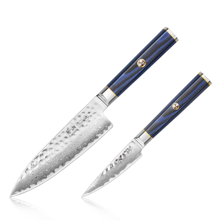 Two blue-handled knives with hammered and patterned Damascus steel blades, one larger chef knife and one smaller paring knife
