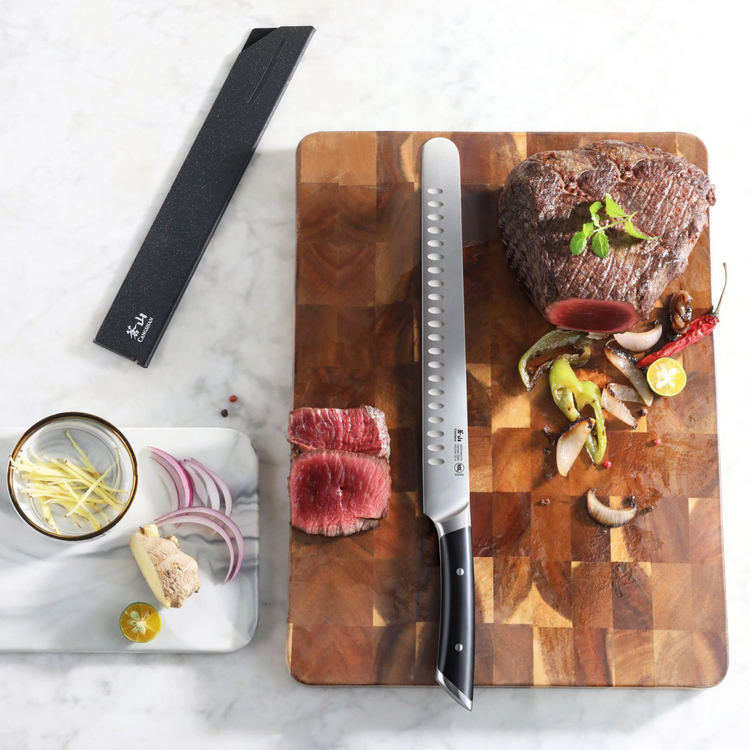 11-inch slicing knife with black handle on wooden board, sliced roast beef, grilled vegetables, and knife sheath nearby.