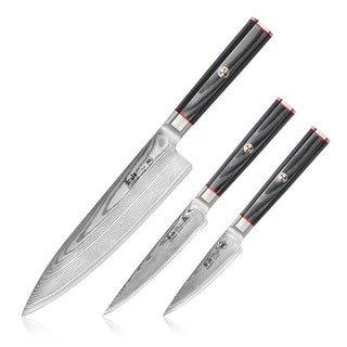 
                    
                      Three kitchen knives with patterned Damascus steel blades and black handles with red accents, arranged side by side.
                    
                  