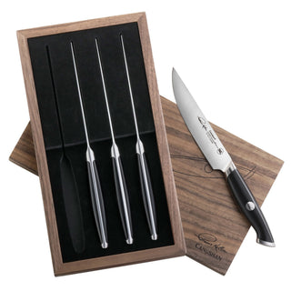 
                    
                      Four black-handled steak knives in a walnut storage box with one knife displayed outside the box.
                    
                  