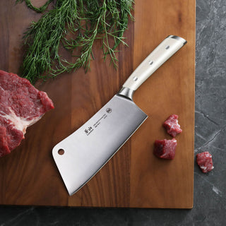 
                    
                      Cleaver knife with stainless steel handle on wooden cutting board next to raw beef and herbs.
                    
                  