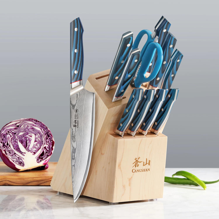 12-piece knife block set with blue-handled knives, kitchen scissors, and maple wood block on countertop.