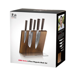 
                    
                      Six kitchen knives with dark handles magnetically attached to a wooden block with a metal base.
                    
                  