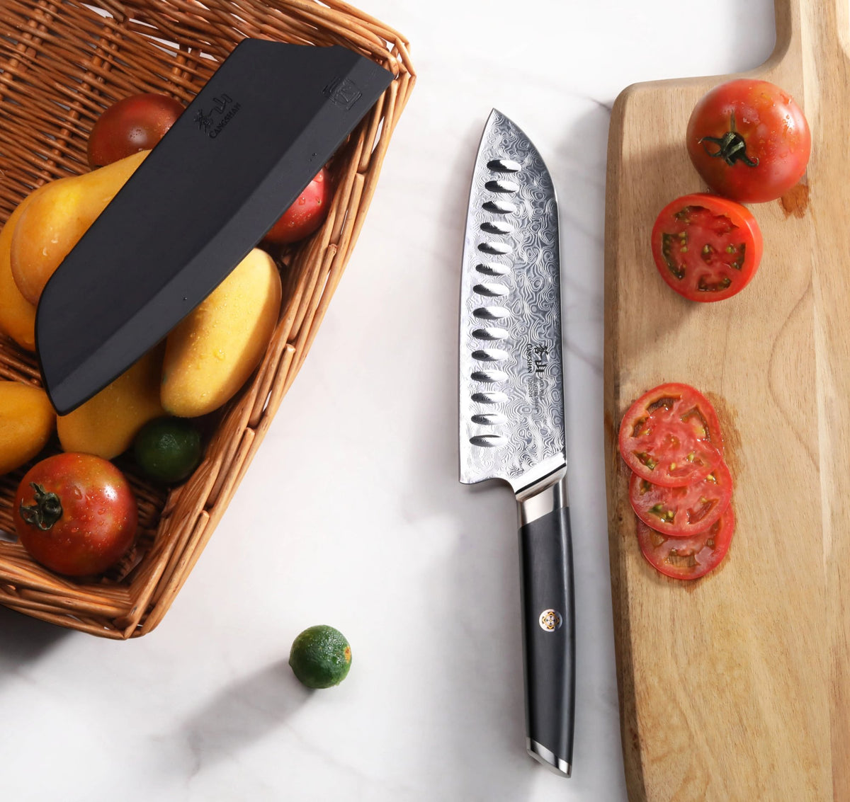 AIRA Series 7-Inch Santoku Knife with 135-Layer Damax™ Steel next to a wooden cutting board with sliced tomatoes.