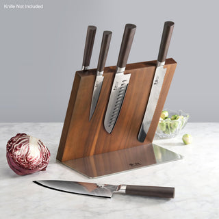 
                    
                      Wooden magnetic knife block holding four knives with dark handles, placed on a marble countertop next to a cabbage and a bowl
                    
                  