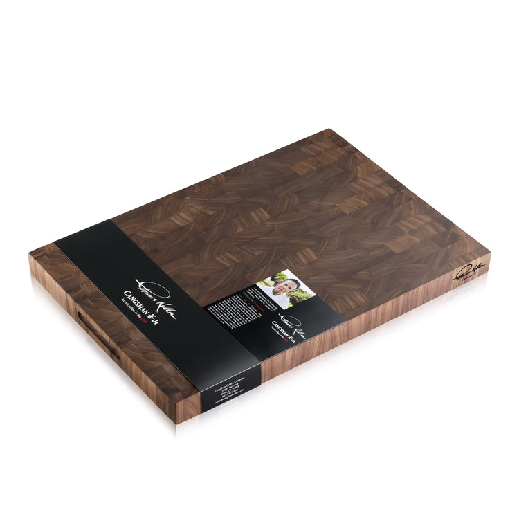 Walnut end-grain cutting board with dark wood pattern and black label from Thomas Keller Signature Collection