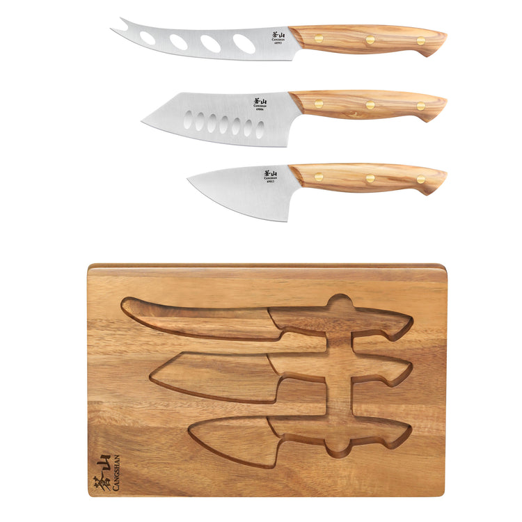 Three cheese knives with olive wood handles above an acacia wood board with matching knife-shaped slots.