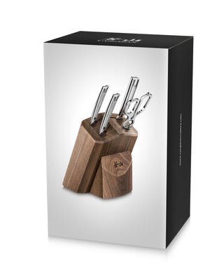 
                    
                      Walnut knife block holding four knives and kitchen shears with polished metal handles.
                    
                  