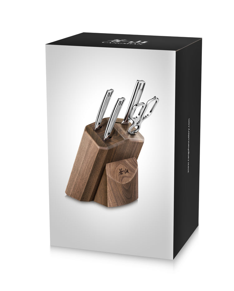 Walnut knife block holding four knives and kitchen shears with polished metal handles.