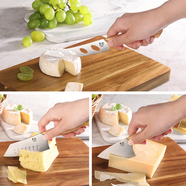 Hand using three different cheese knives to cut soft, Swiss, and hard cheese on a wooden board.