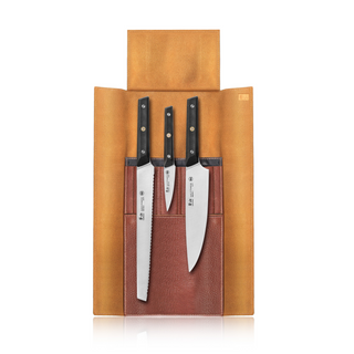 
                    
                      Three kitchen knives with black handles secured in a brown leather roll with three pockets, flap open.
                    
                  