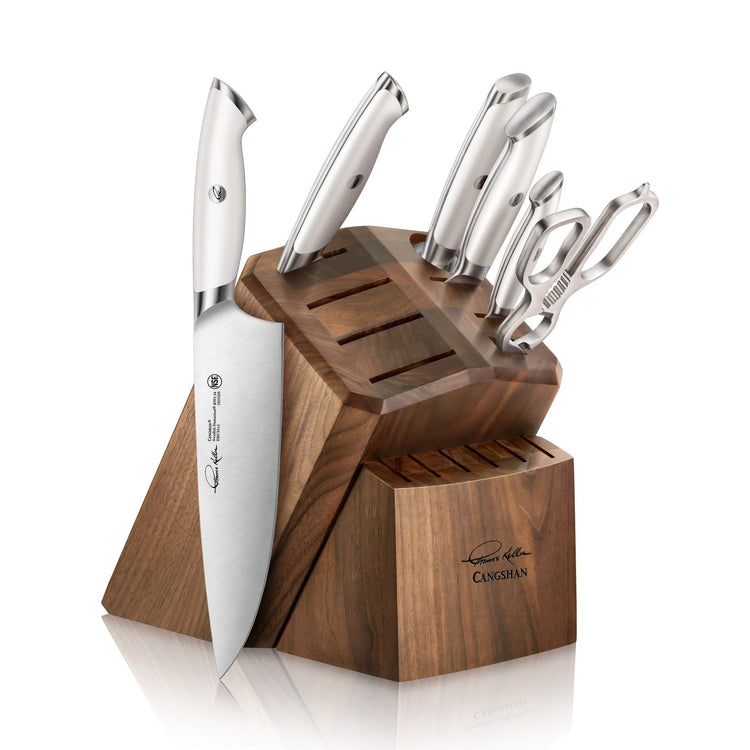 Wooden knife block holding six stainless steel knives and kitchen shears, with eight empty slots visible.